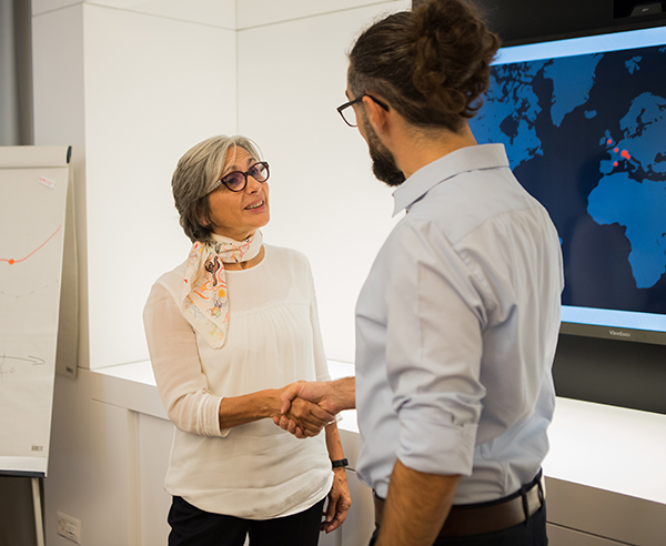 An employee and customer shaking hands